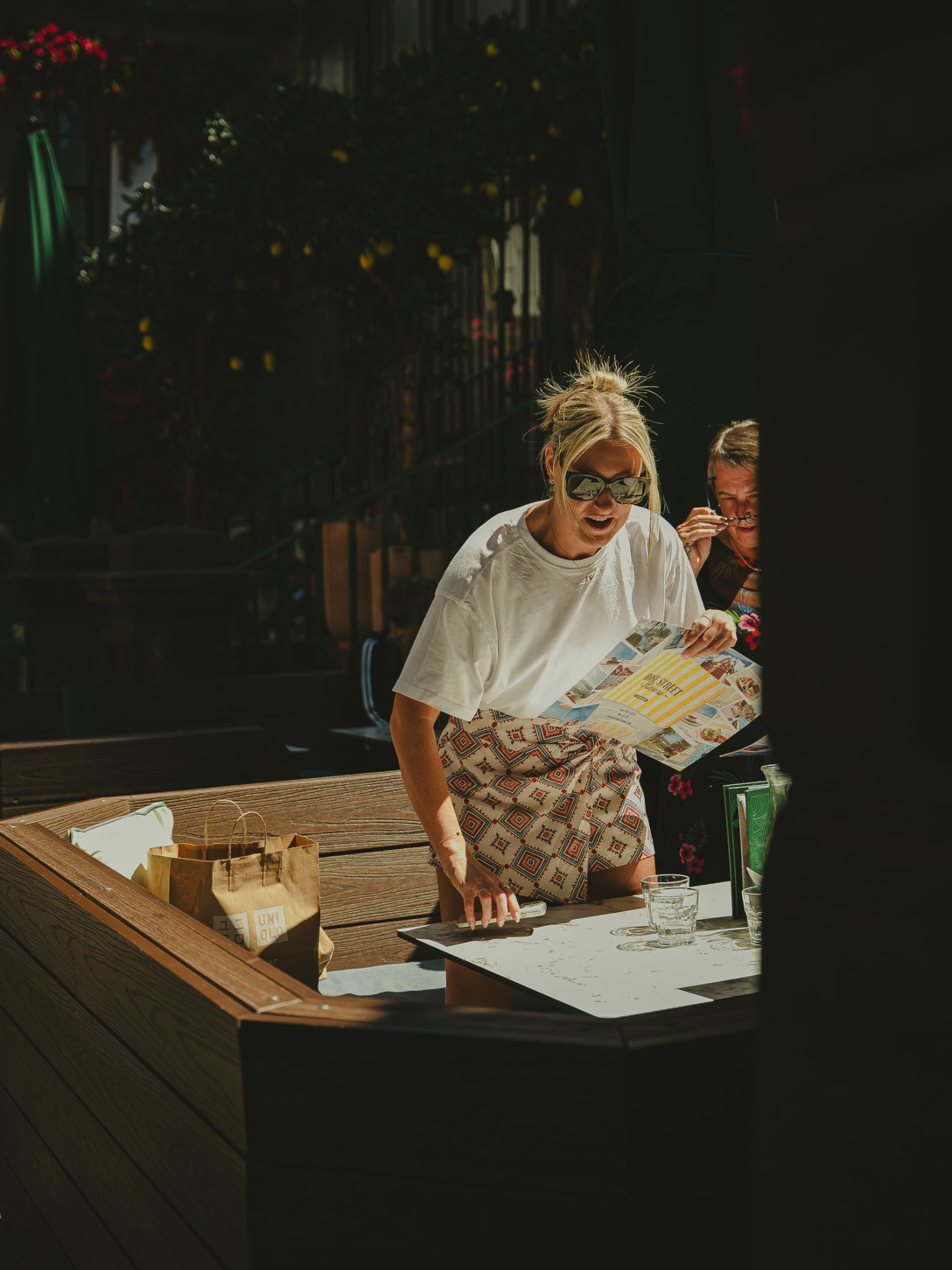 Guest reading the menu in a pool of sunlight at Rose Street Garden, Edinburgh