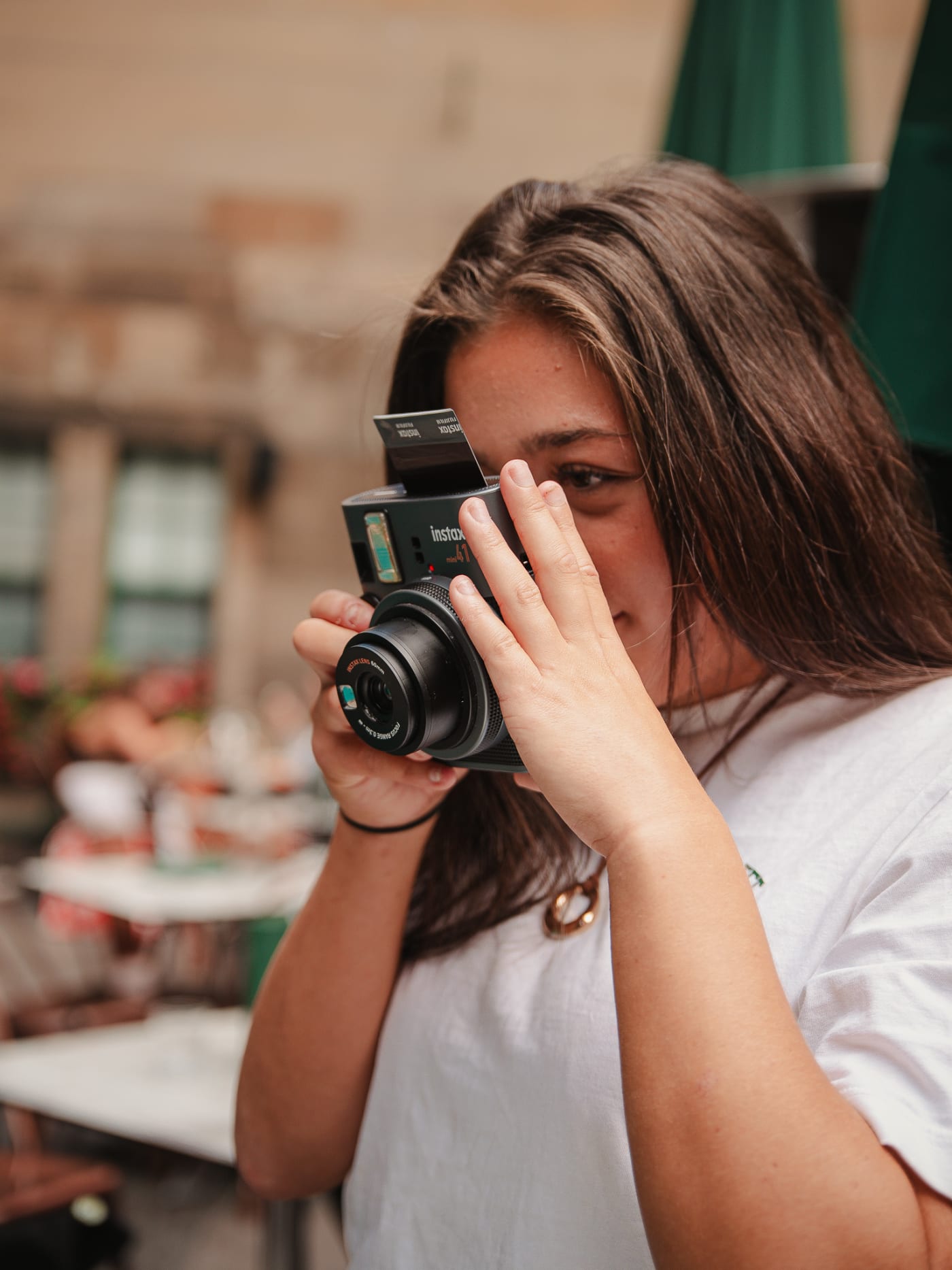 Guest shooting an instant camera at Rose Street Garden, Edinburgh