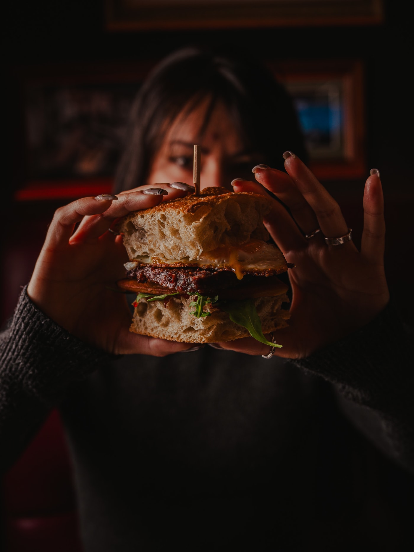 Guest tucking into a stacked sandwich at Ryan’s of Edinburgh