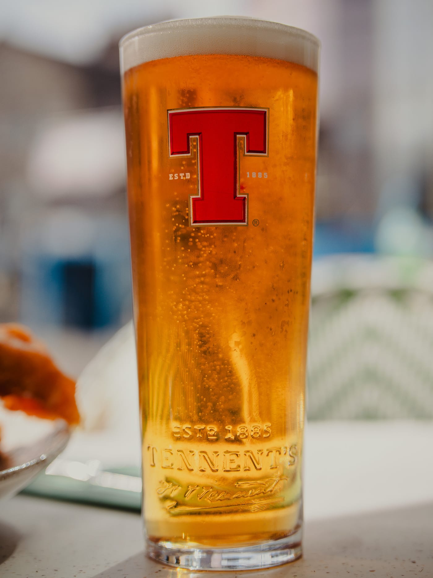 Pint of Tennent’s glowing on the sunny terrace at Ryan’s of Edinburgh