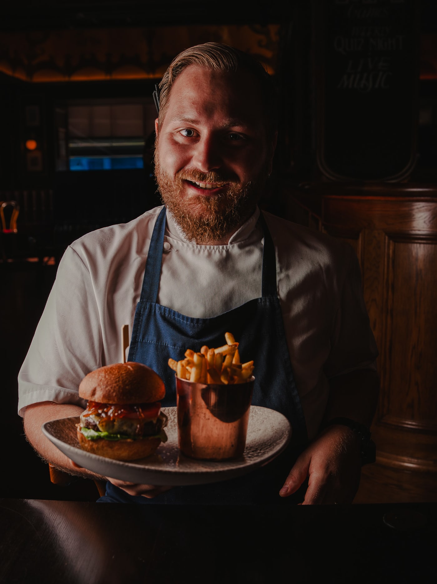 Chef presenting the house burger at Ryan’s of Edinburgh