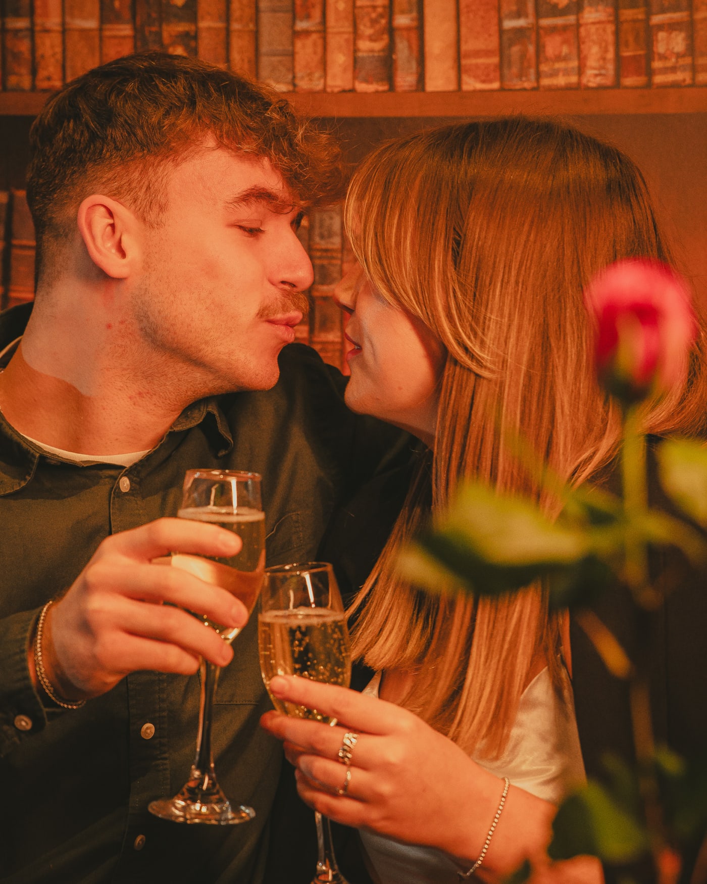 Couple celebrating Valentine's Day with champagne and a rose at Ryan's of Edinburgh