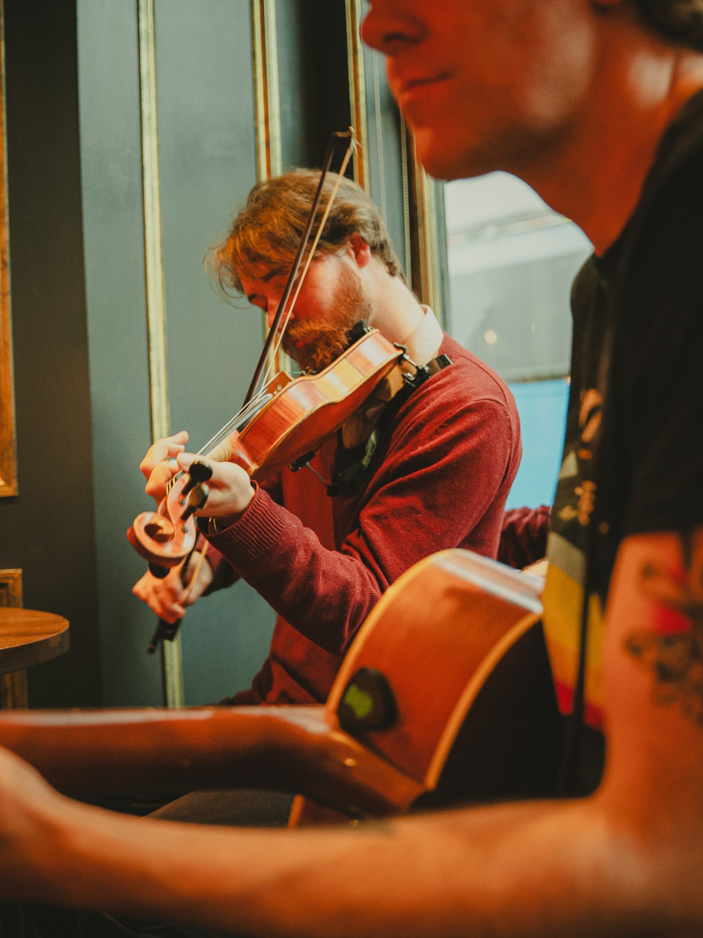Violinist mid-tune during a live folk session at Ryan's of Edinburgh