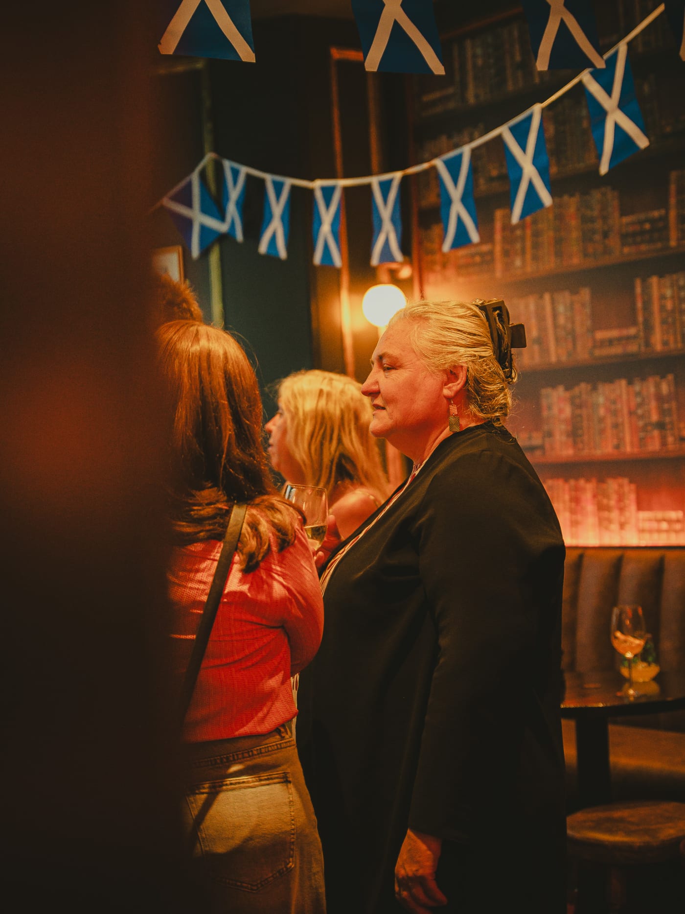 Guests chatting under Scotland flags at Ryan's of Edinburgh