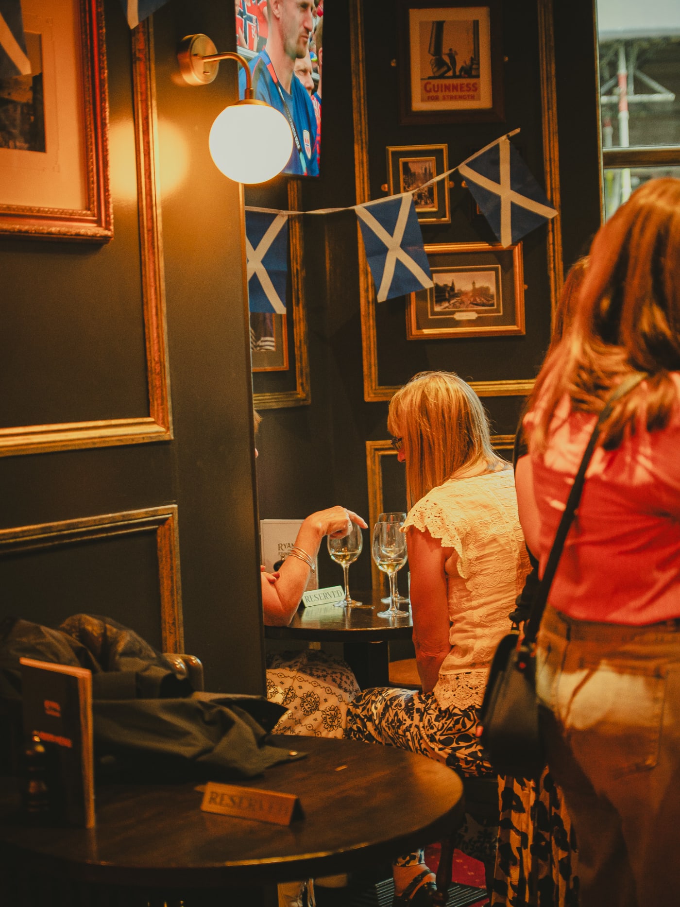 Friends at the mirror wall of Ryan's of Edinburgh on a match day