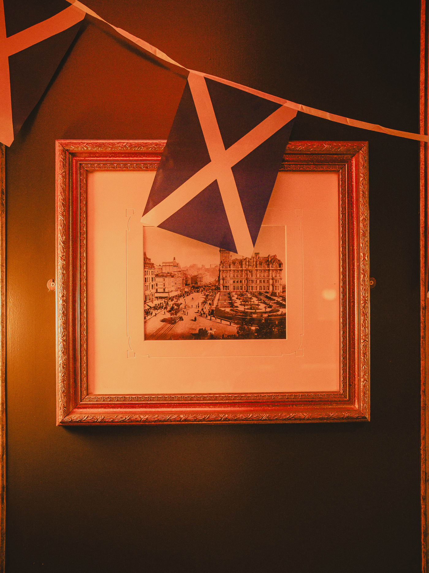 Saltire bunting over a vintage Edinburgh print at Ryan's of Edinburgh