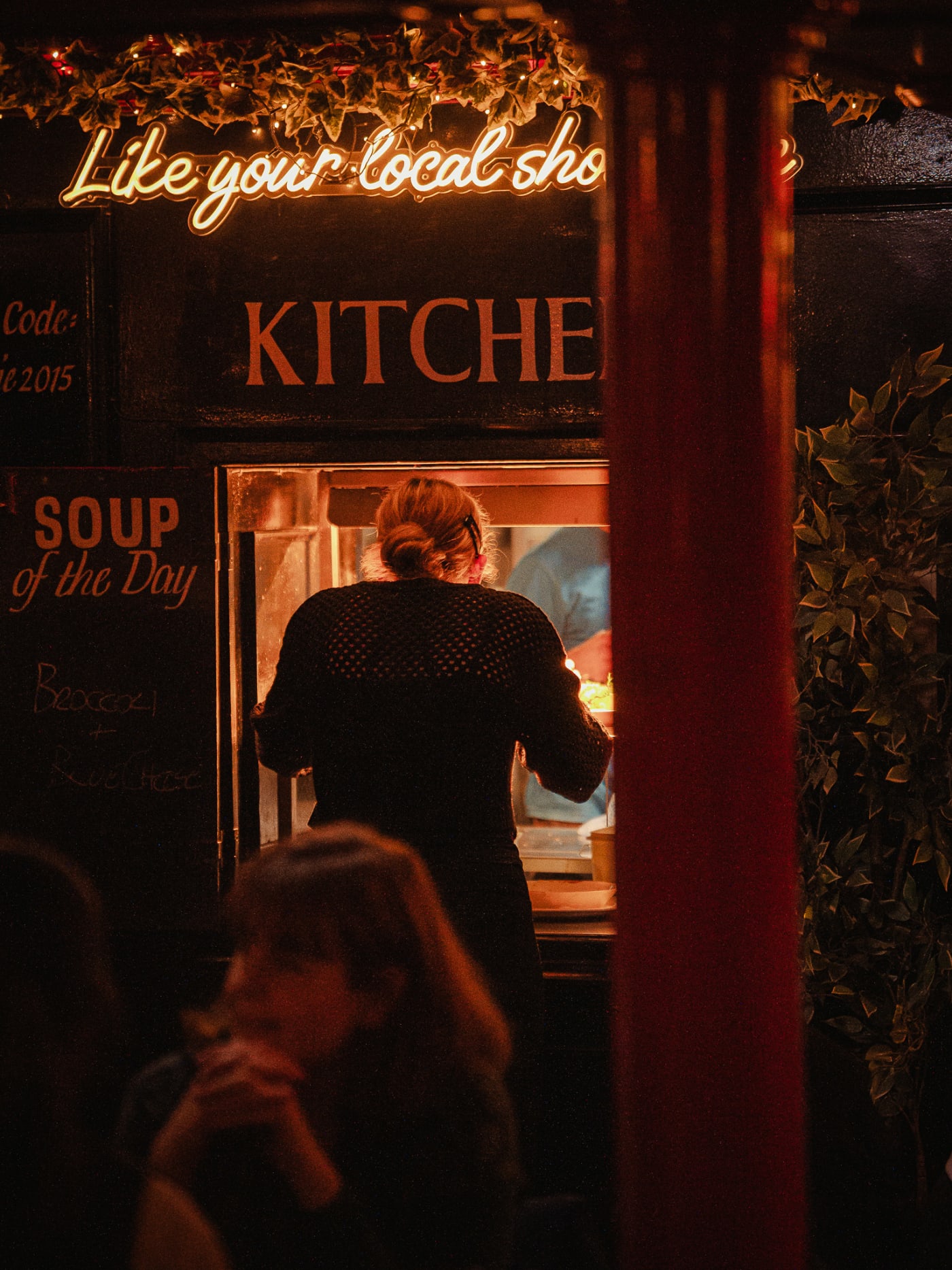 Guests by the kitchen doorway at The Bailie Bar