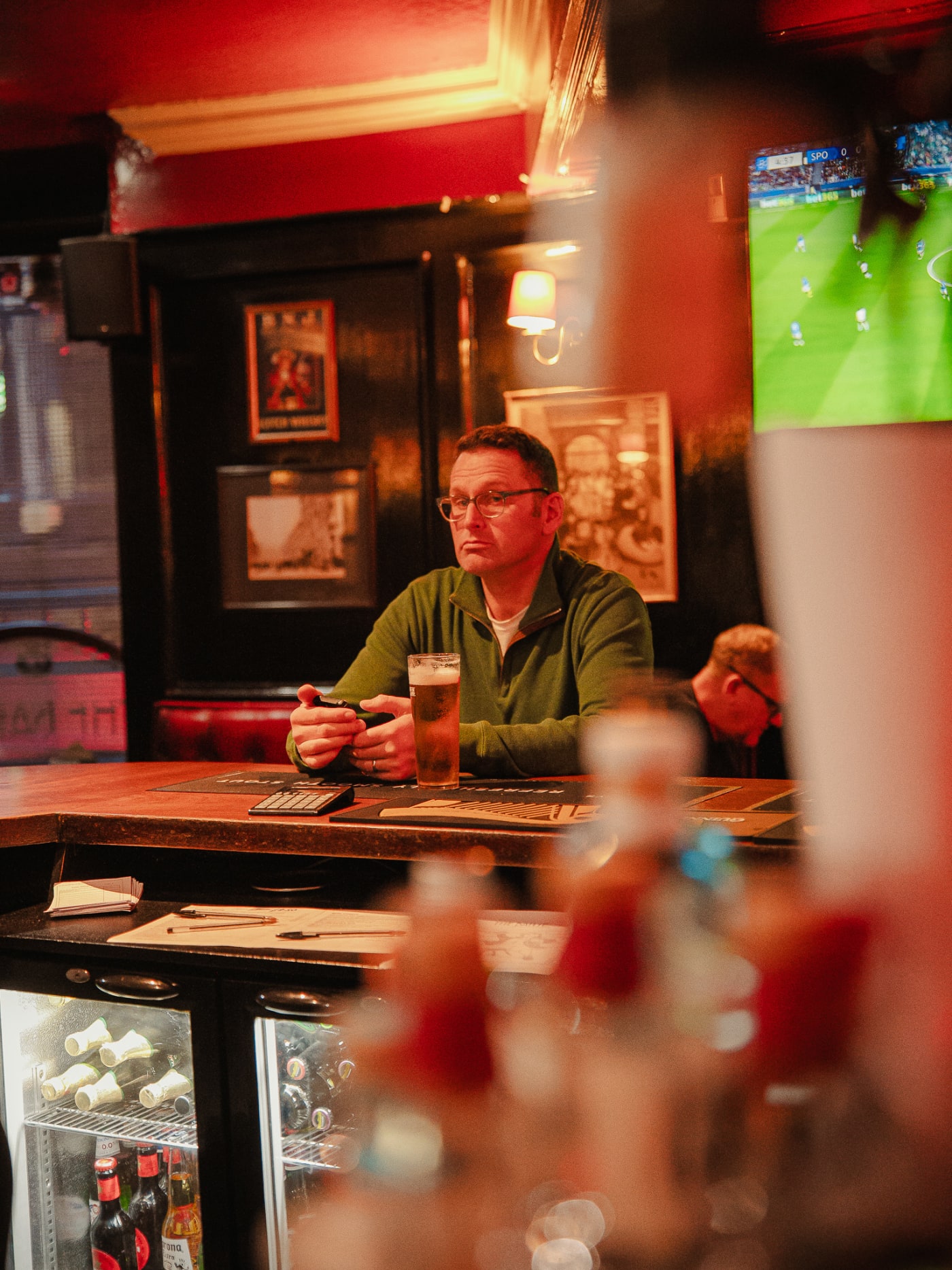 Guest enjoying a pint at the bar at The Bailie Bar