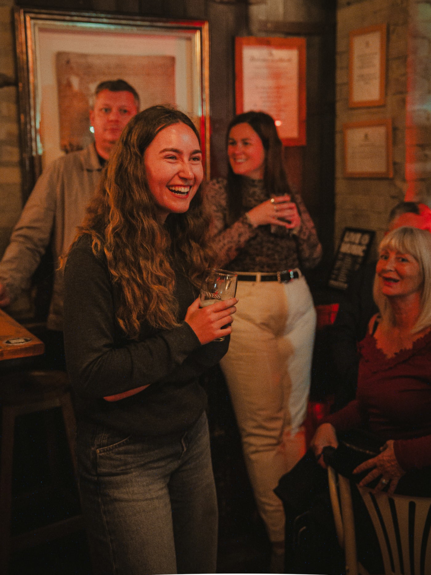 Guests laughing at the bar at The Piper's Rest