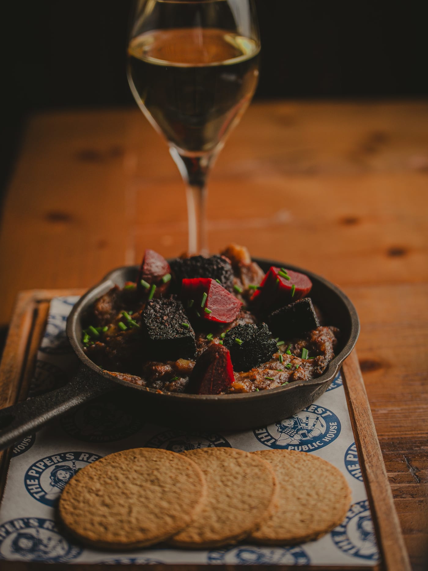 Sharing board with a glass of white wine at The Piper's Rest