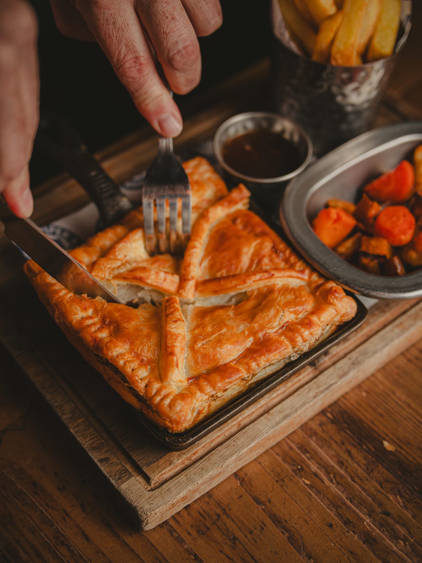 Cutting into a pastry pie at The Piper's Rest