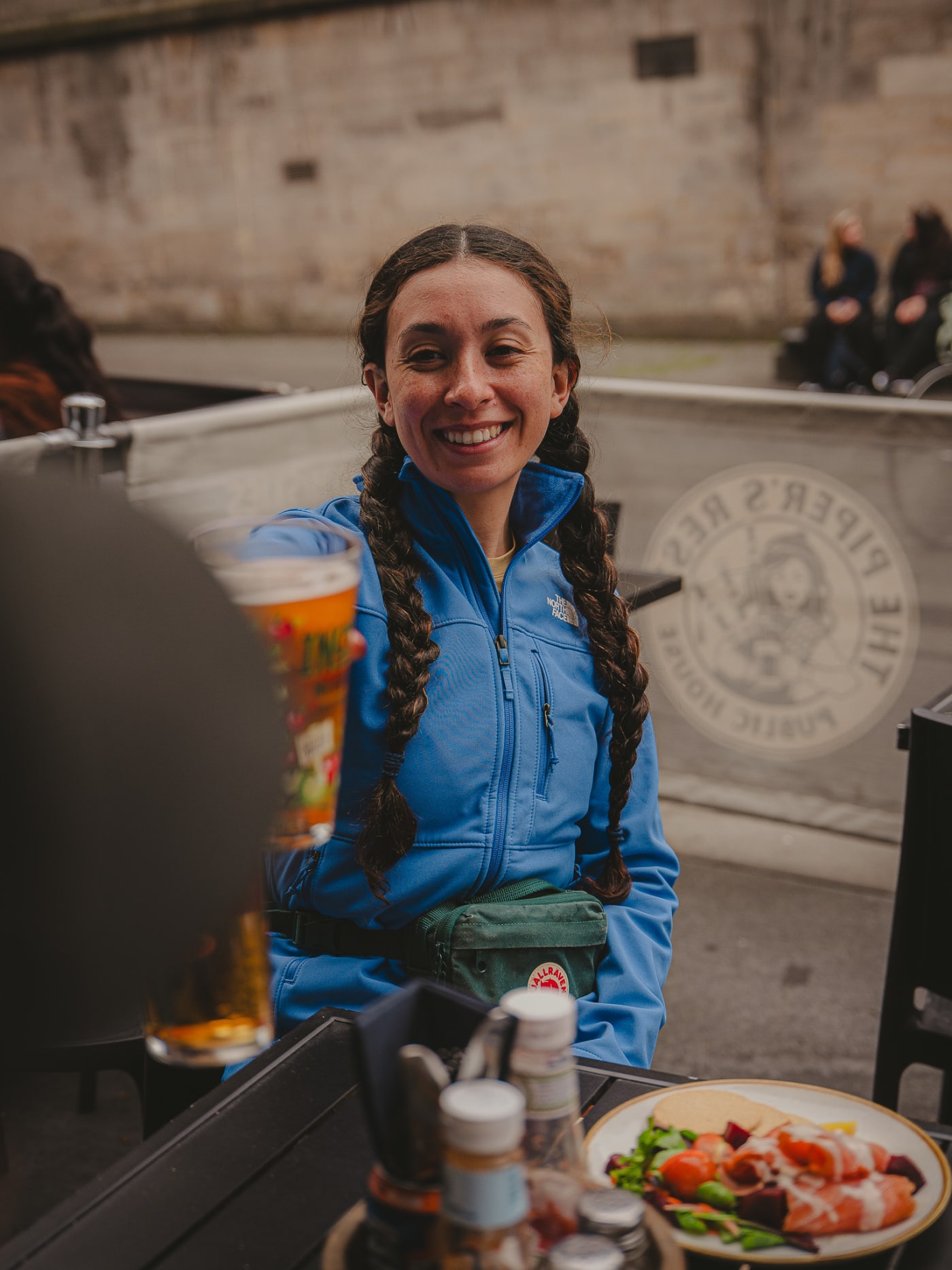 Guest with a pint on the terrace at The Piper's Rest