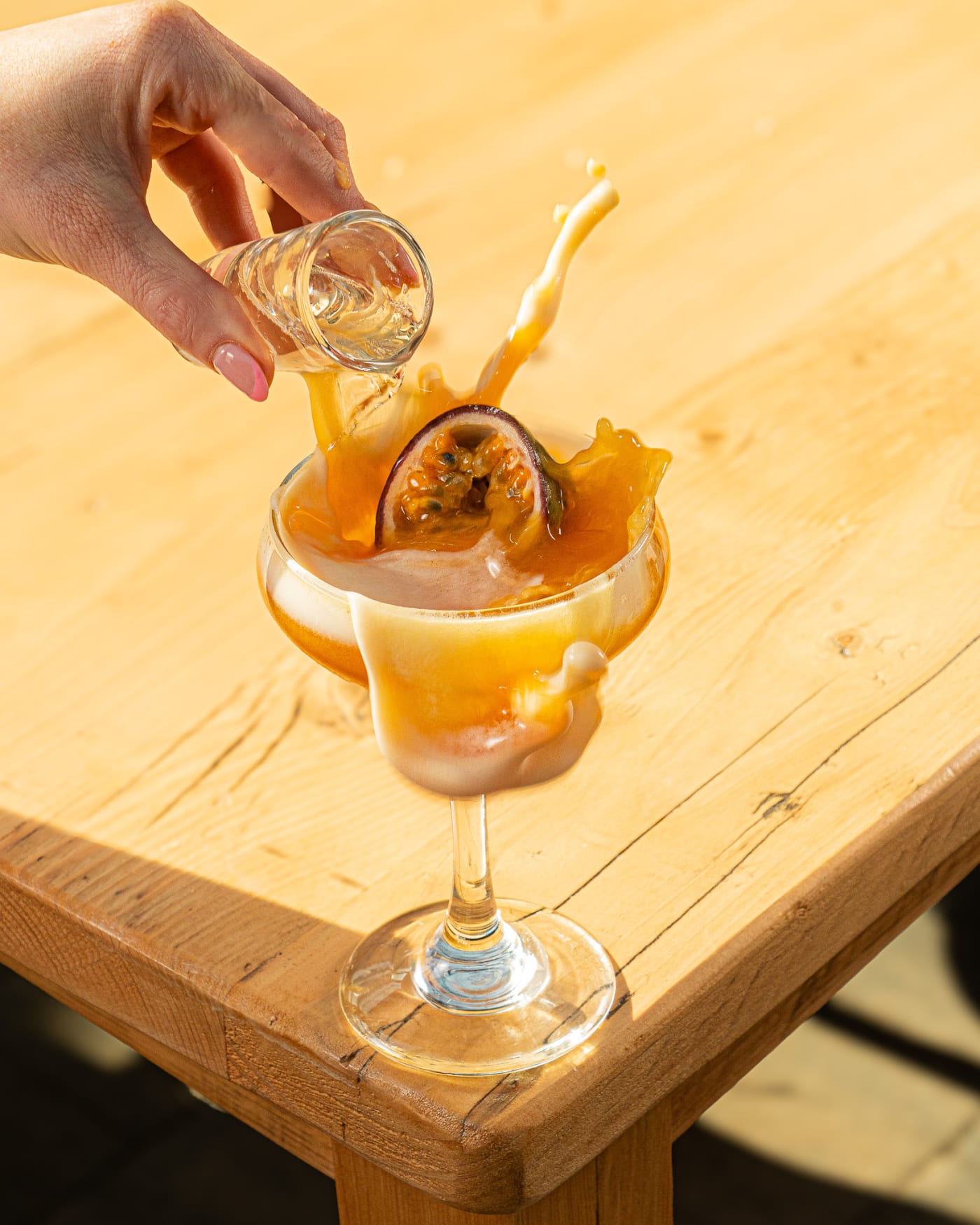 Bartender garnishing a cocktail with a dehydrated orange at The Ship Inn