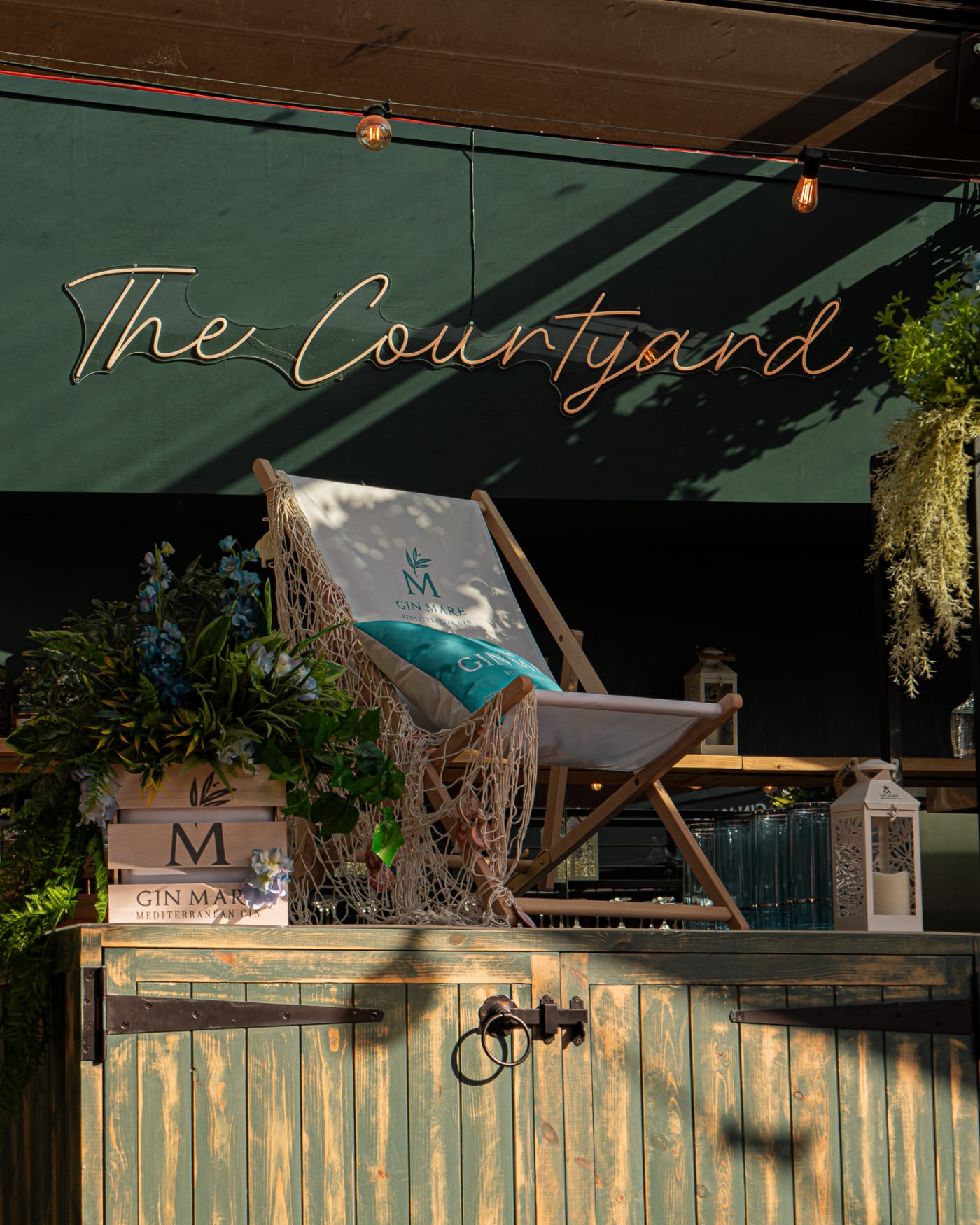 The Courtyard bar area with a deck chair at The Ship Inn