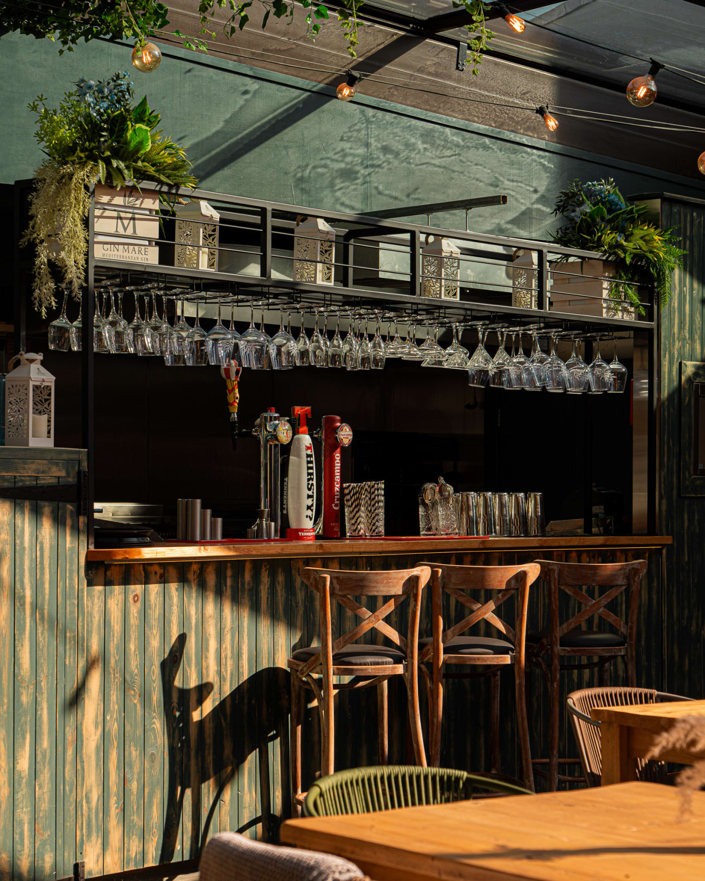 The Courtyard bar with hanging glassware at The Ship Inn