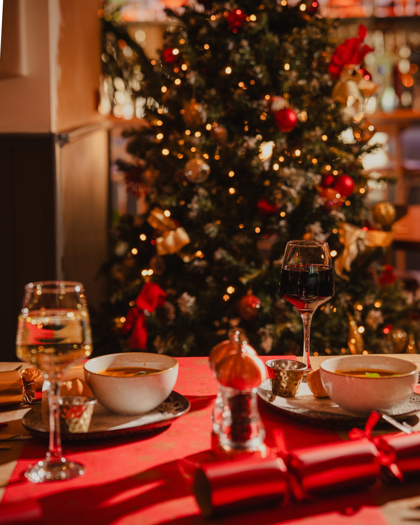 Christmas dinner table set beside the tree at The Ship Inn