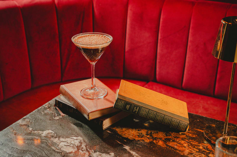 Espresso martini on stacked books at Jackson The Tailor