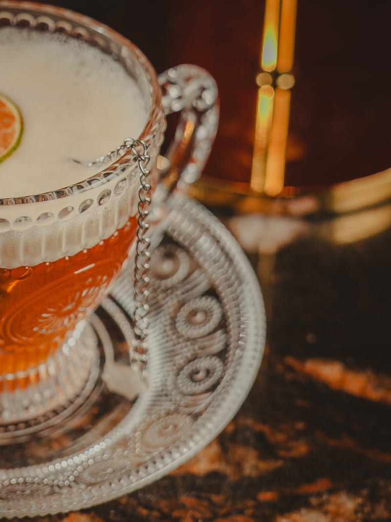 Sour served in an engraved glass teacup at Jackson The Tailor