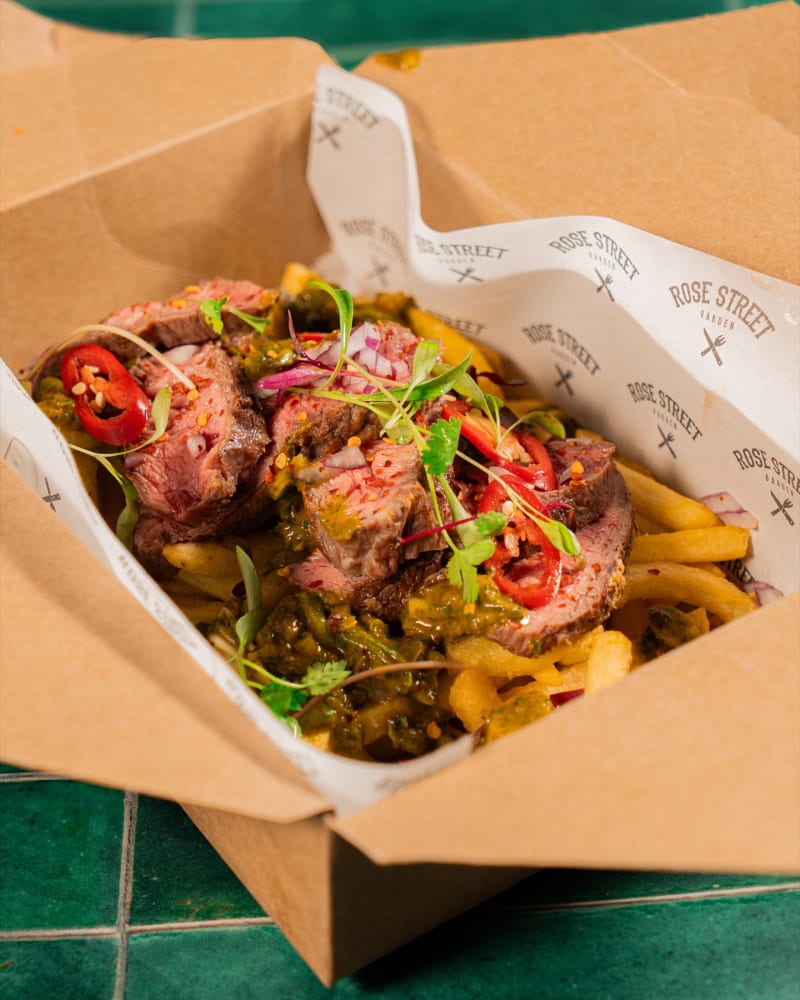 Steak-loaded fries in a branded box at Rose Street Garden, Edinburgh