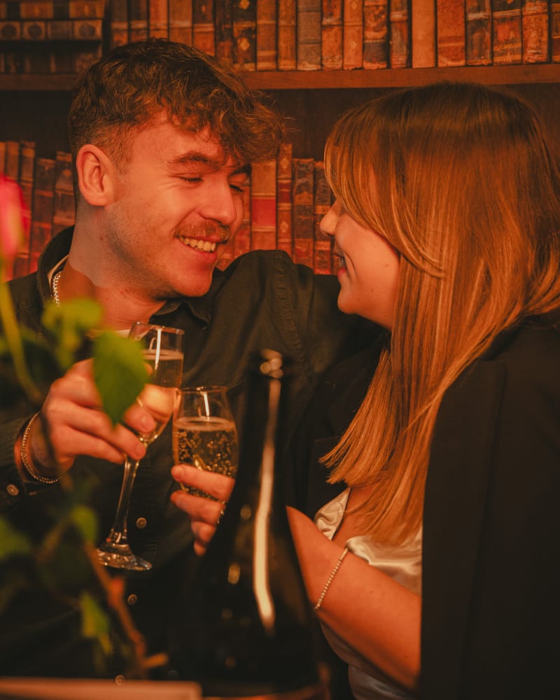 Couple laughing over champagne on Valentine's Day at Ryan's of Edinburgh