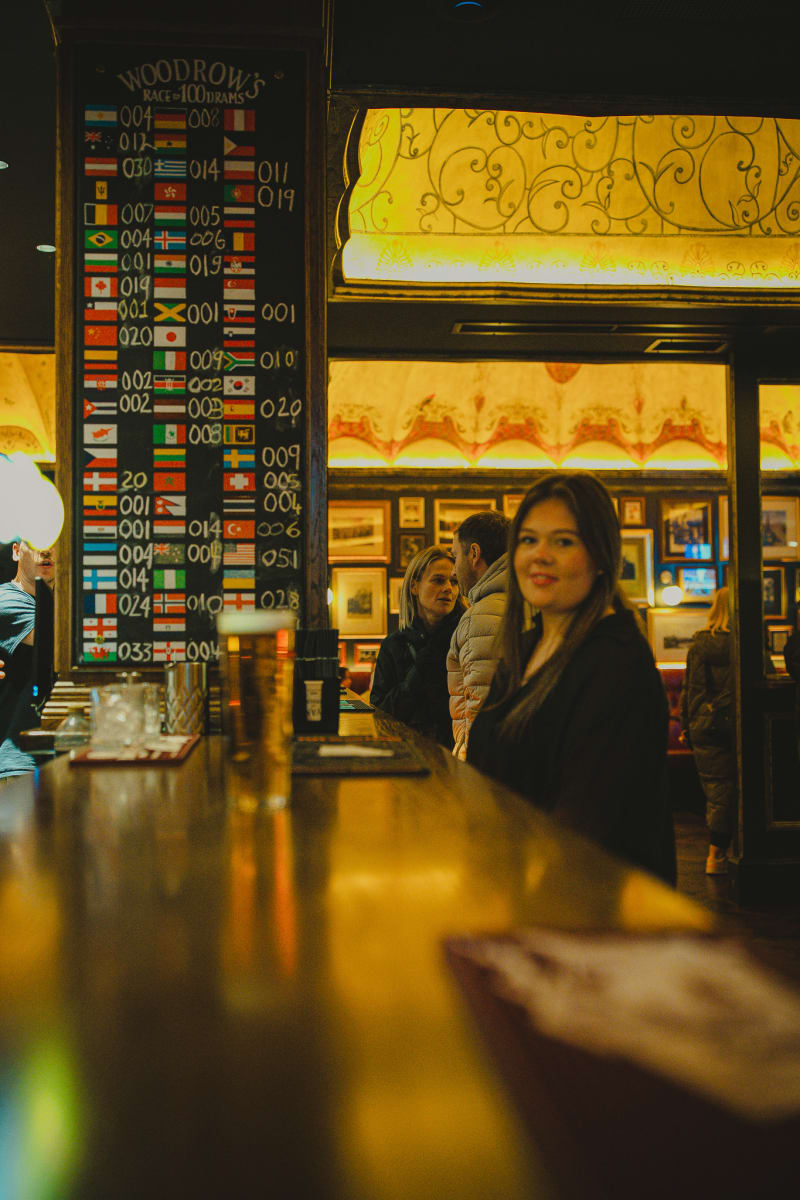 Bartender at the flag-lined bar of Ryan's of Edinburgh