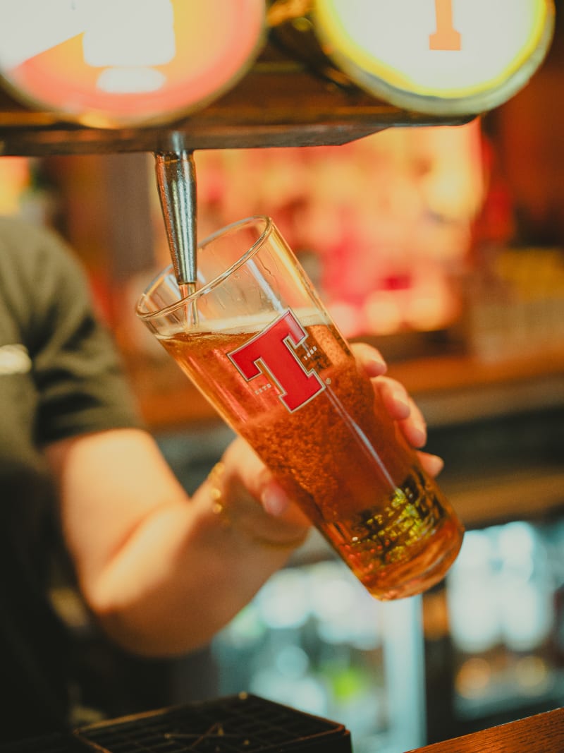 Fresh pint of Tennent's poured at the tap at Ryan's of Edinburgh