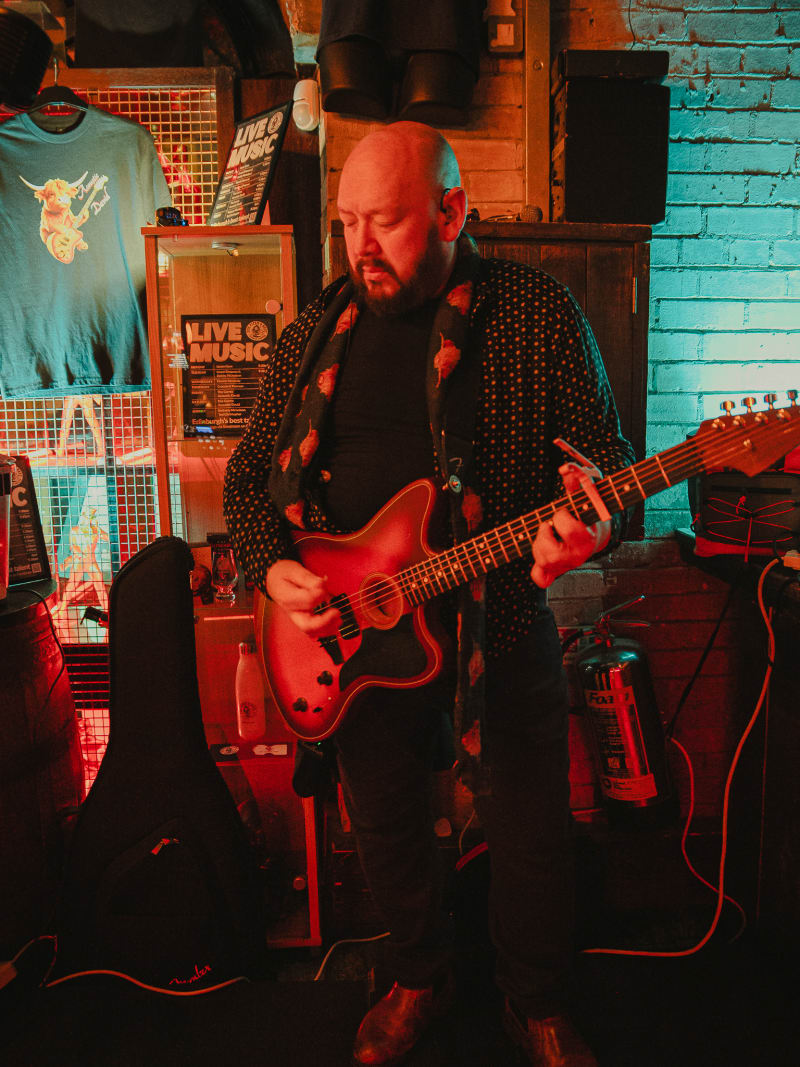 Live guitarist performing at The Piper's Rest, Edinburgh