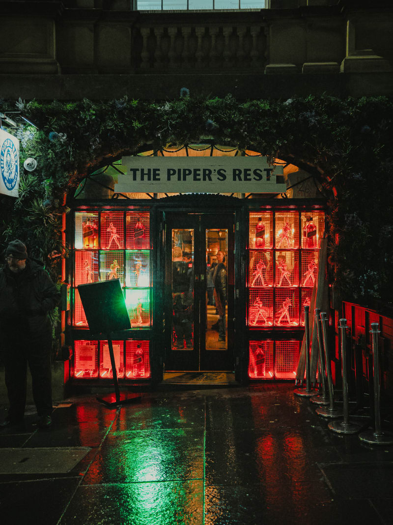 The Piper's Rest neon sign at the entrance, Edinburgh