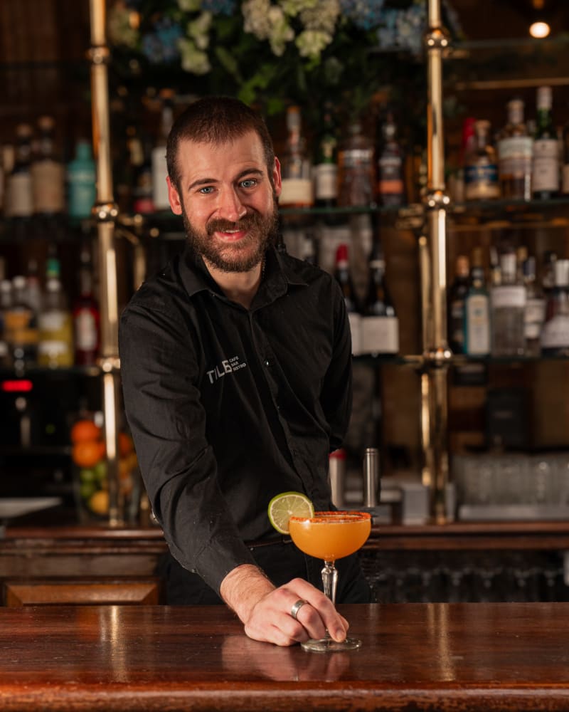Bartender presenting a cocktail at Tiles Bar, Edinburgh