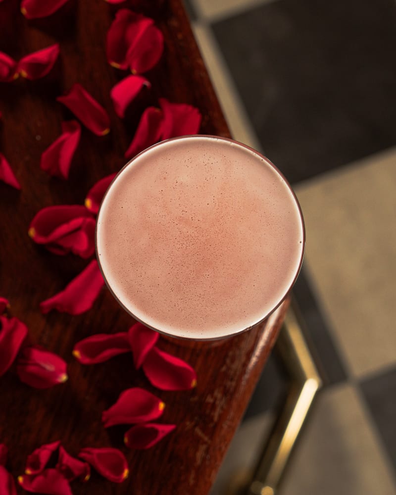 Pink cocktail on a bed of rose petals at Tiles Bar