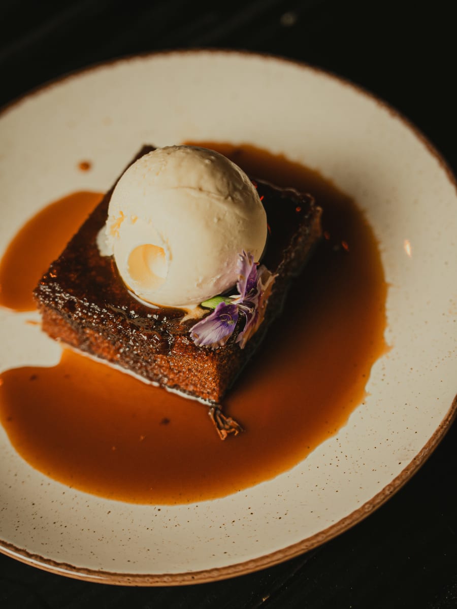 Sticky toffee pudding with vanilla ice cream and toffee sauce at Merchant Tavern, Edinburgh