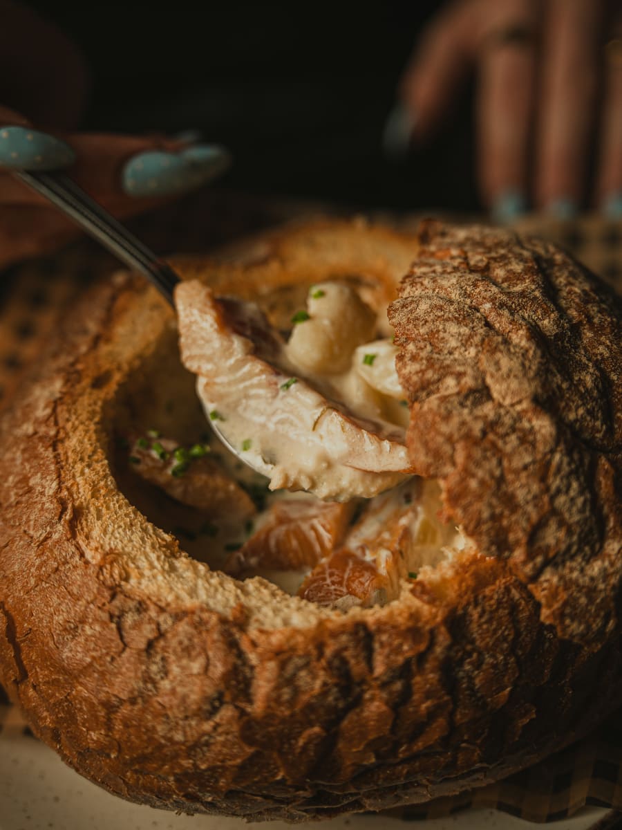 Spoonful of smoked fish lifted from the cullen skink bread bowl at Merchant Tavern, Edinburgh