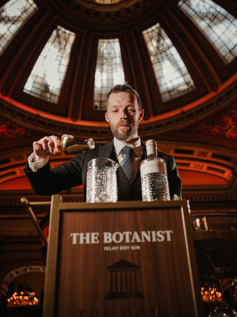 Bartender preparing The Botanist martinis beneath the dome ceiling at The Dome