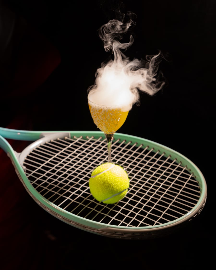 Smoking cocktail balanced on a vintage tennis racket for The Dome's Wimbledon campaign