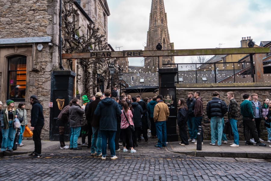 The Pear Tree beer garden crowd with the church tower behind, Edinburgh