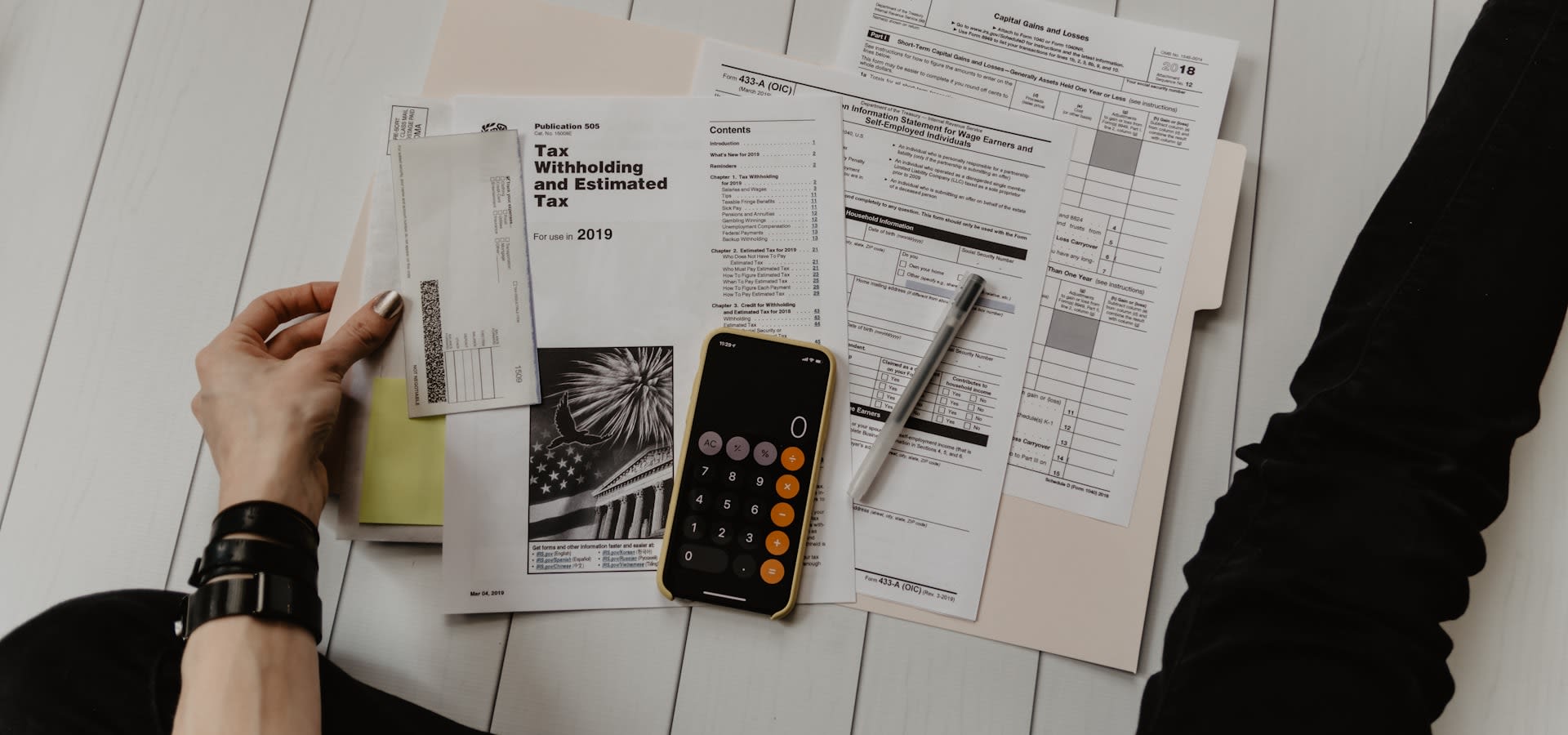 Calculator and financial records on a bookkeeper's desk