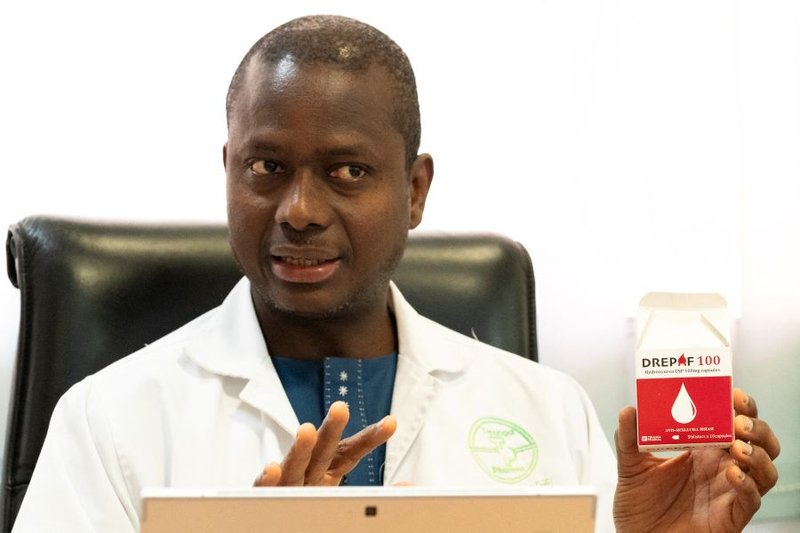 Senegalese pharmacist and Teranga Pharma CEO Dr. Mouhamadou Sow displays a box of DREPAF, a generic formulation used to treat sickle cell disease