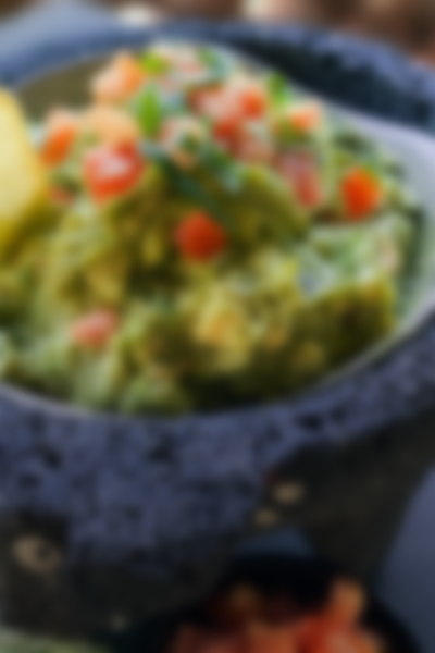 freshly made guacamole with cilantro and tomato