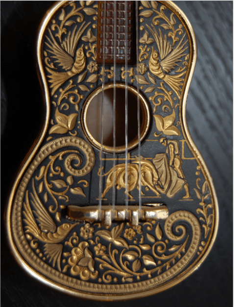 Black guitar with gold carvings