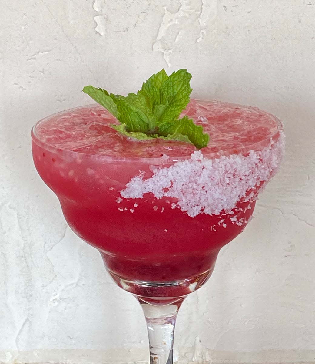 cranberry apple margarita on the rocks with salt on rim