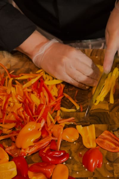 chef in kitchen chopping fresh ingredients