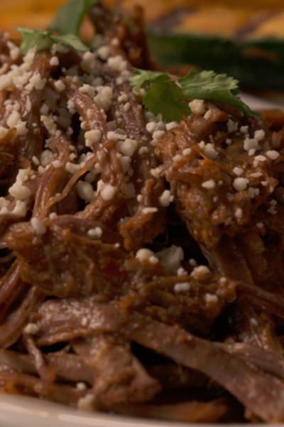barbacoa beef on a plate with vegetables