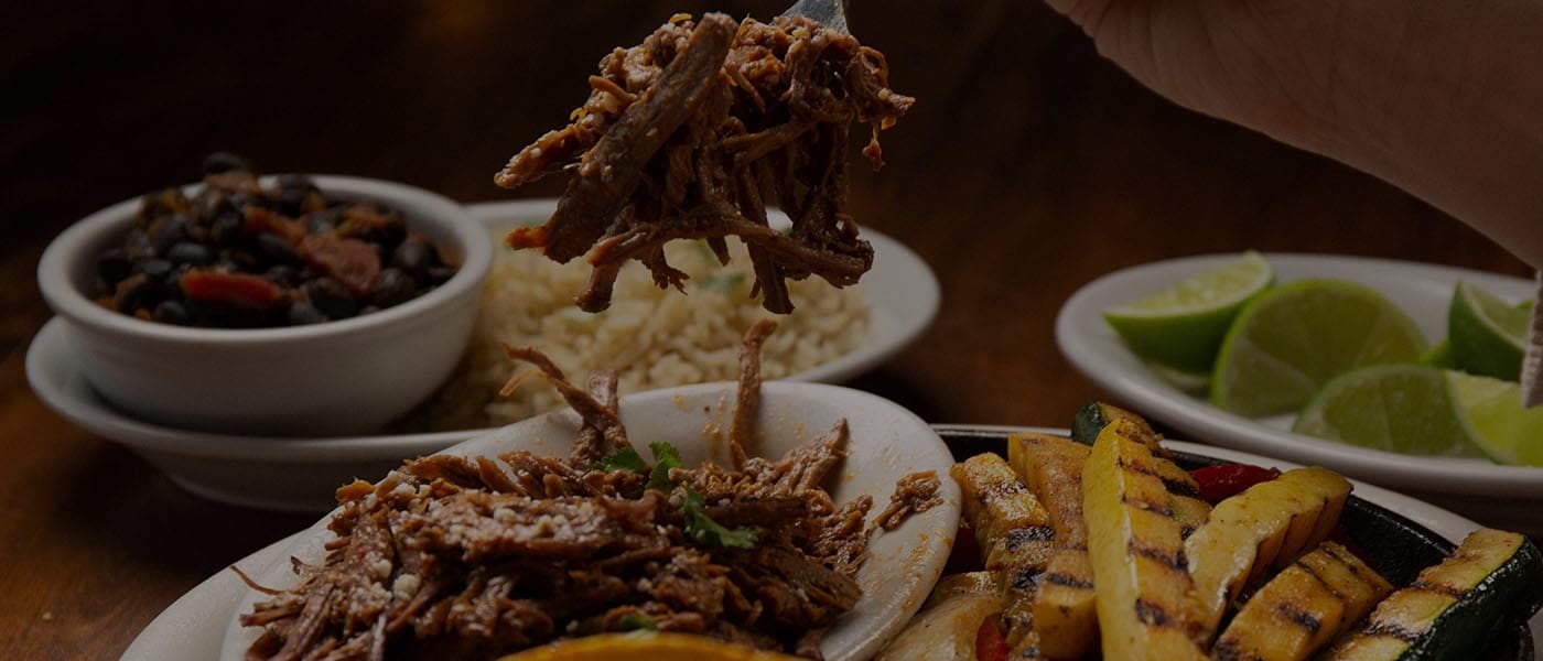 barbacoa beef fajitas with grilled vegetables and side of rice and beans