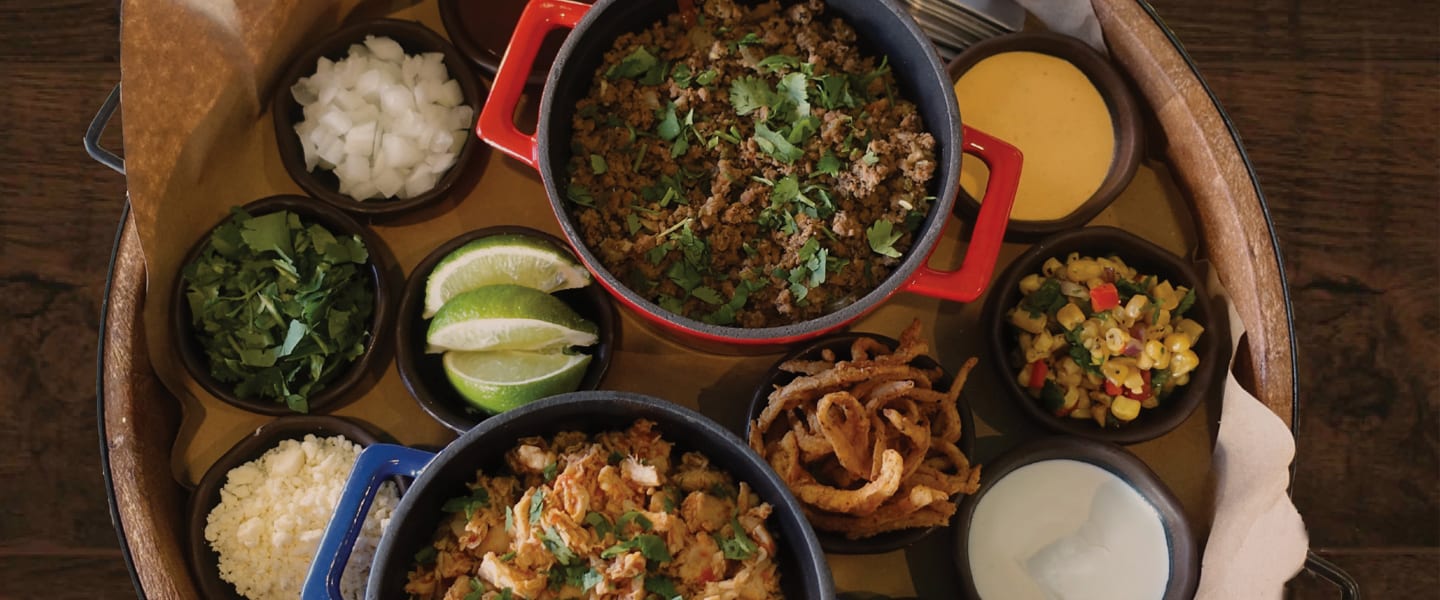 Taco bar with ground beef, shredded chicken