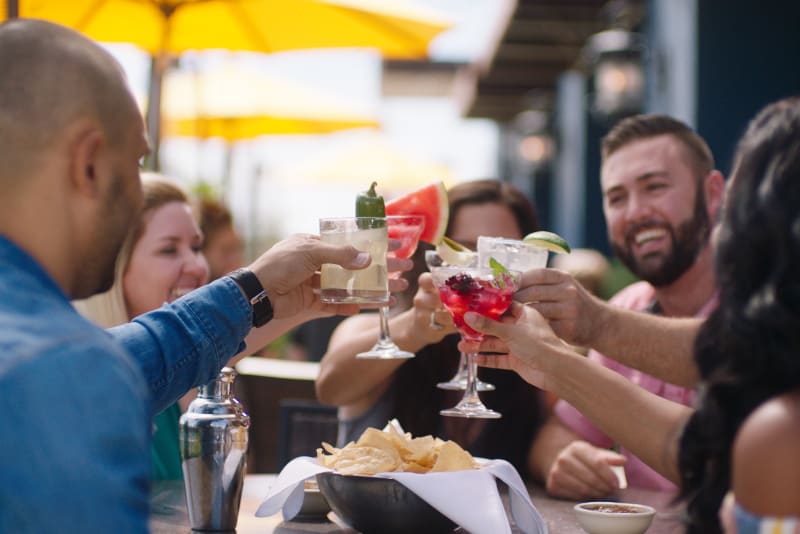 Group of people dining out on the Uncle Julio’s patio and enjoying beverages