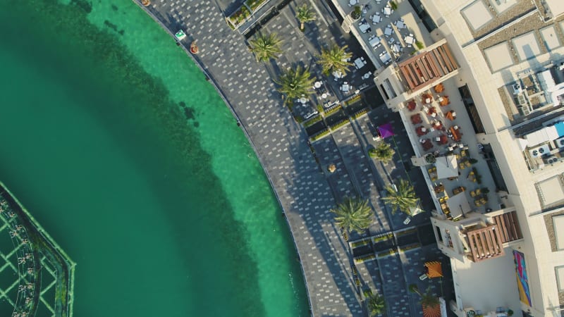 Aerial view of a luxury beach with palm trees.