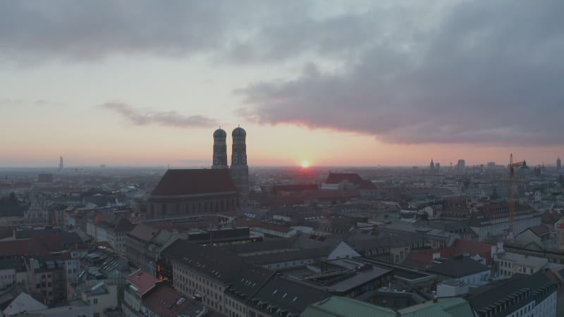 Cloudscape above Munich, germany at Sunset with Frauenkirche Cathedral, Famous Building in Big german city, Aerial lift up