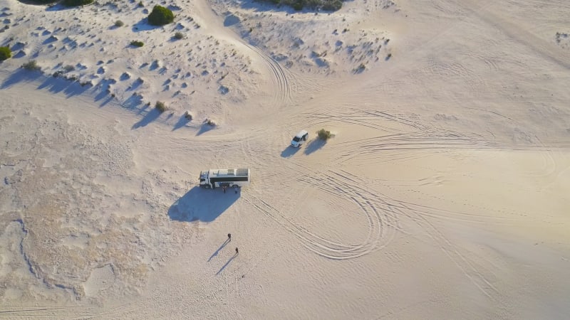 Aerial view of a drone flying over massive sand dunes in Lancelin, Australia