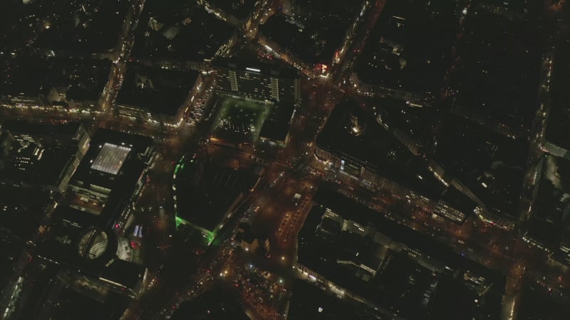 AERIAL: Beautiful Overhead Shot of busy intersection at night with Car traffic and city lights