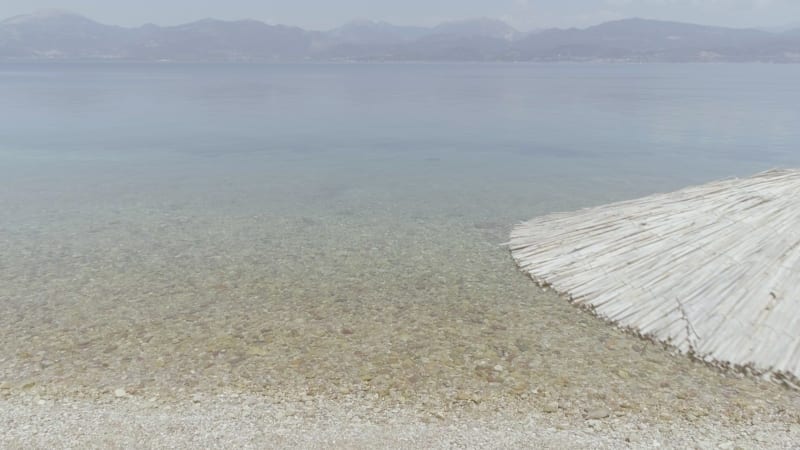 Aerial view of two women sits on the beach in Panagopoula.